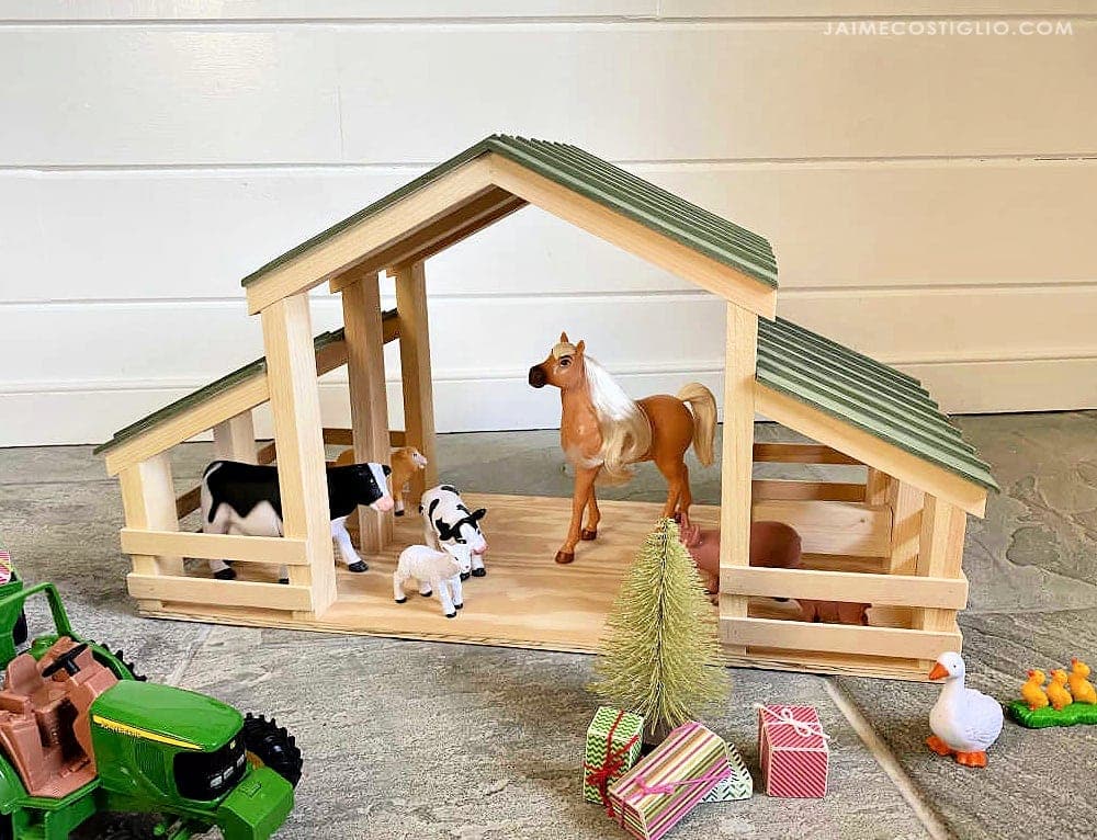 Toy barn with stables and an angled roof, built from thin plywood