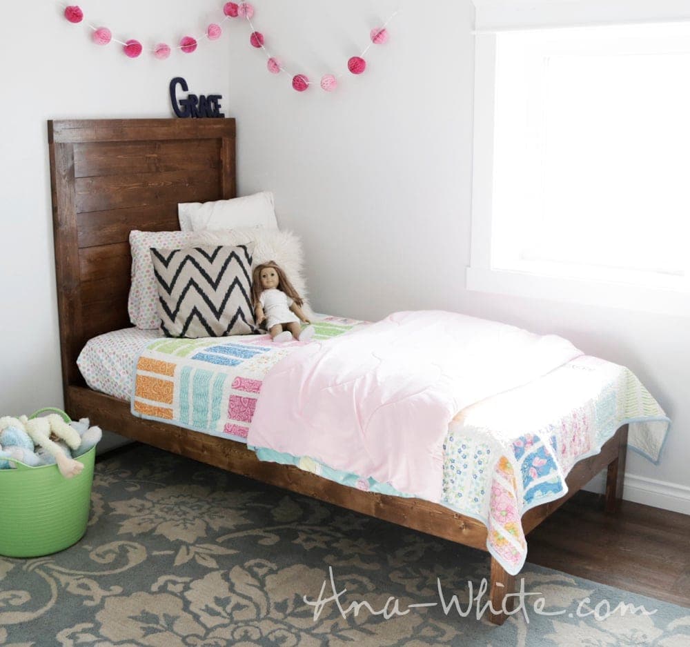 Simple planked wood bed with 2x4 legs and a slat platform
